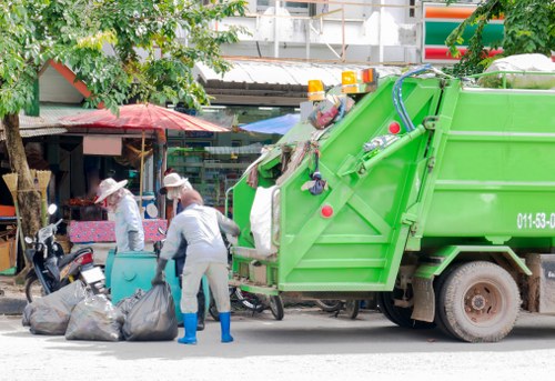 Advisor preparing a written free quote for skip hire